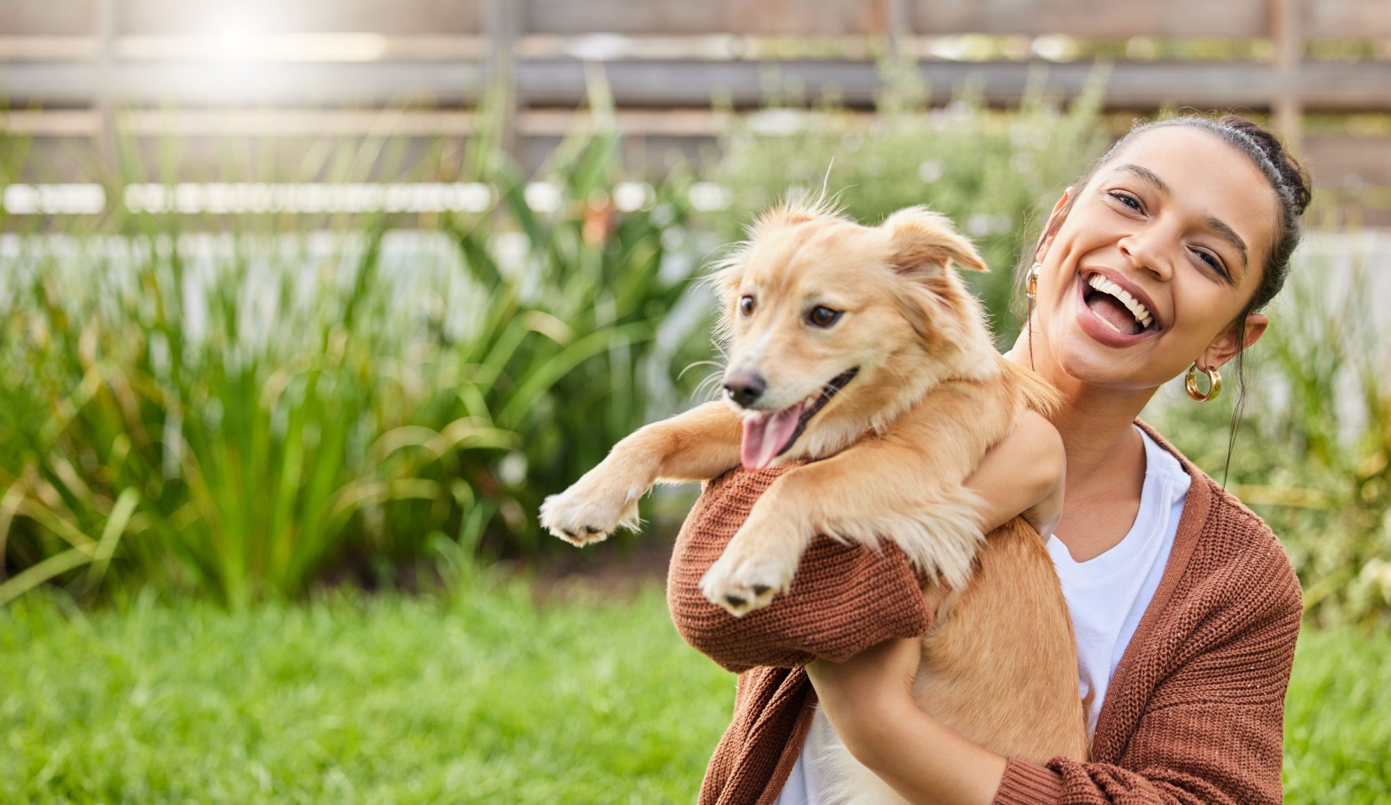 A woman holds her adopted puppy.